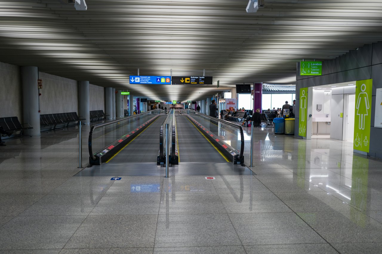 A moving walkway stretching through a modern terminal
